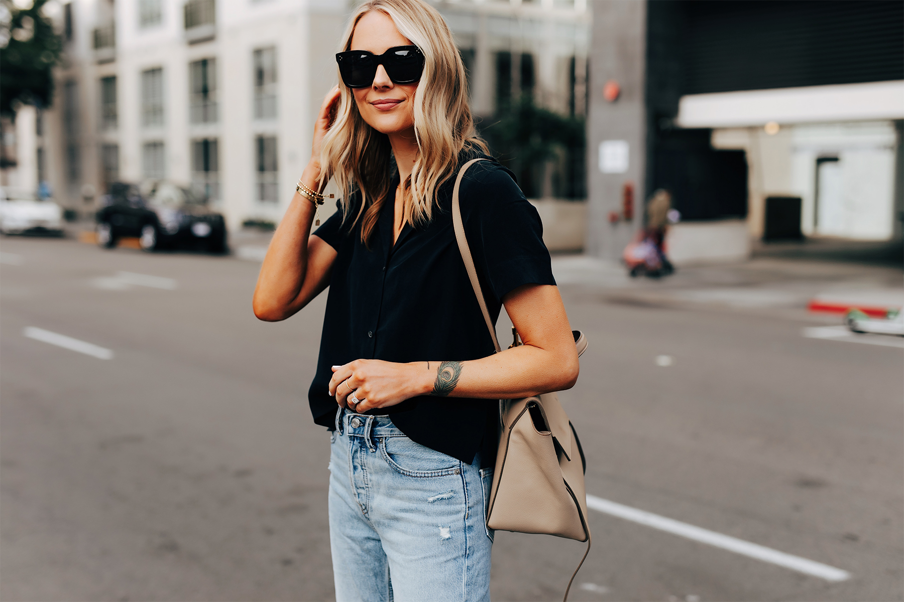 Fashion Jackson Wearing Everlane Black Silk Button Down Short Sleeve Top Ripped Jeans