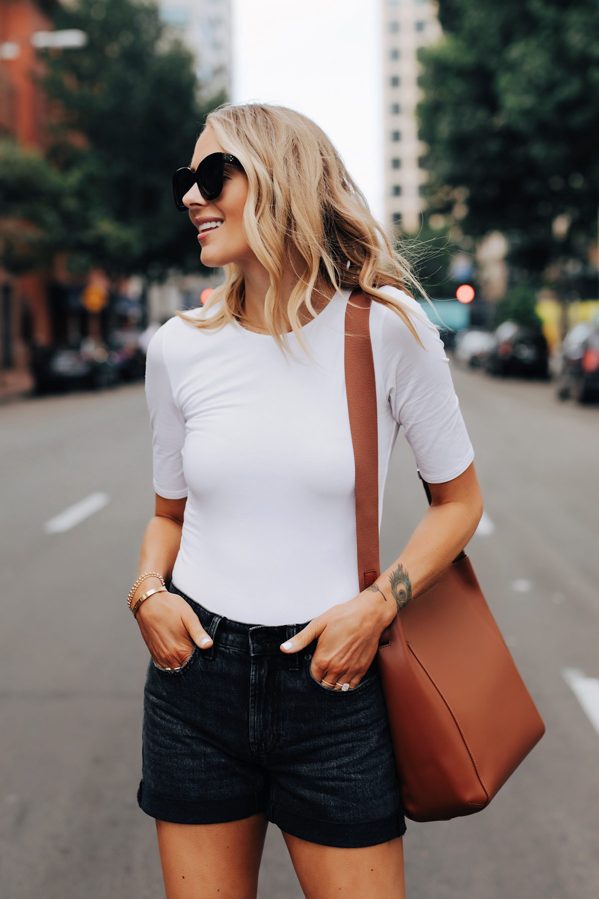 Fashion Jackson Wearing Everlane White Bodysuit Everlane Black Denim Shorts Everlane Messenger Bag