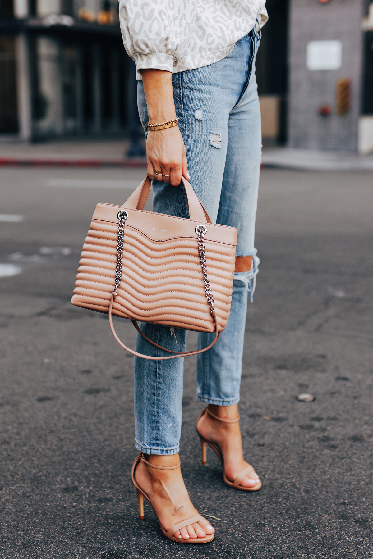 Fashion Jackson Holding Rebecca Minkoff MAB Quilted Satchel Blush Ripped Denim Jeans Tan Ankle Strap Heeled Sandals