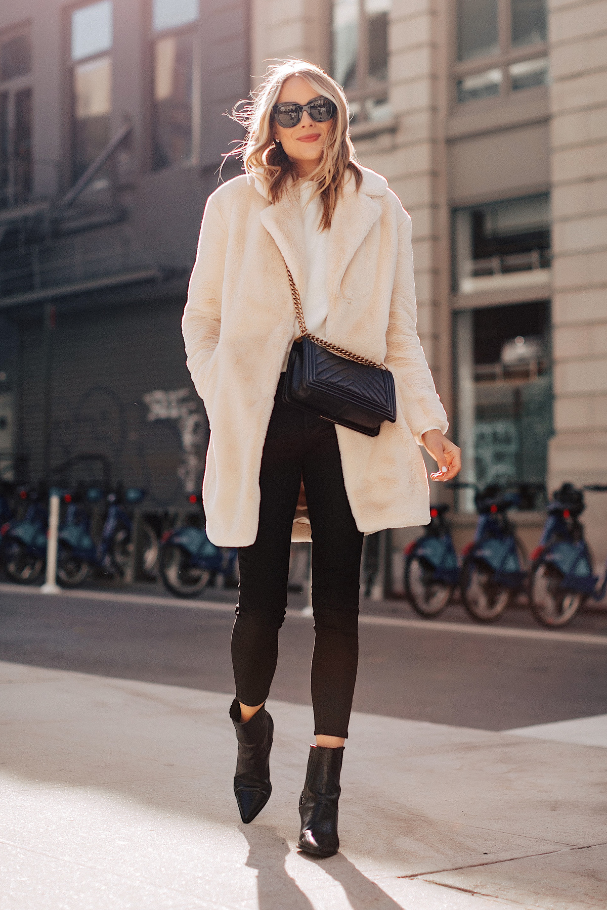 Fashion Jackson Wearing White Faux Fur Coat White Sweater Black Coated Skinny Jeans Black Booties New York Street Style 1
