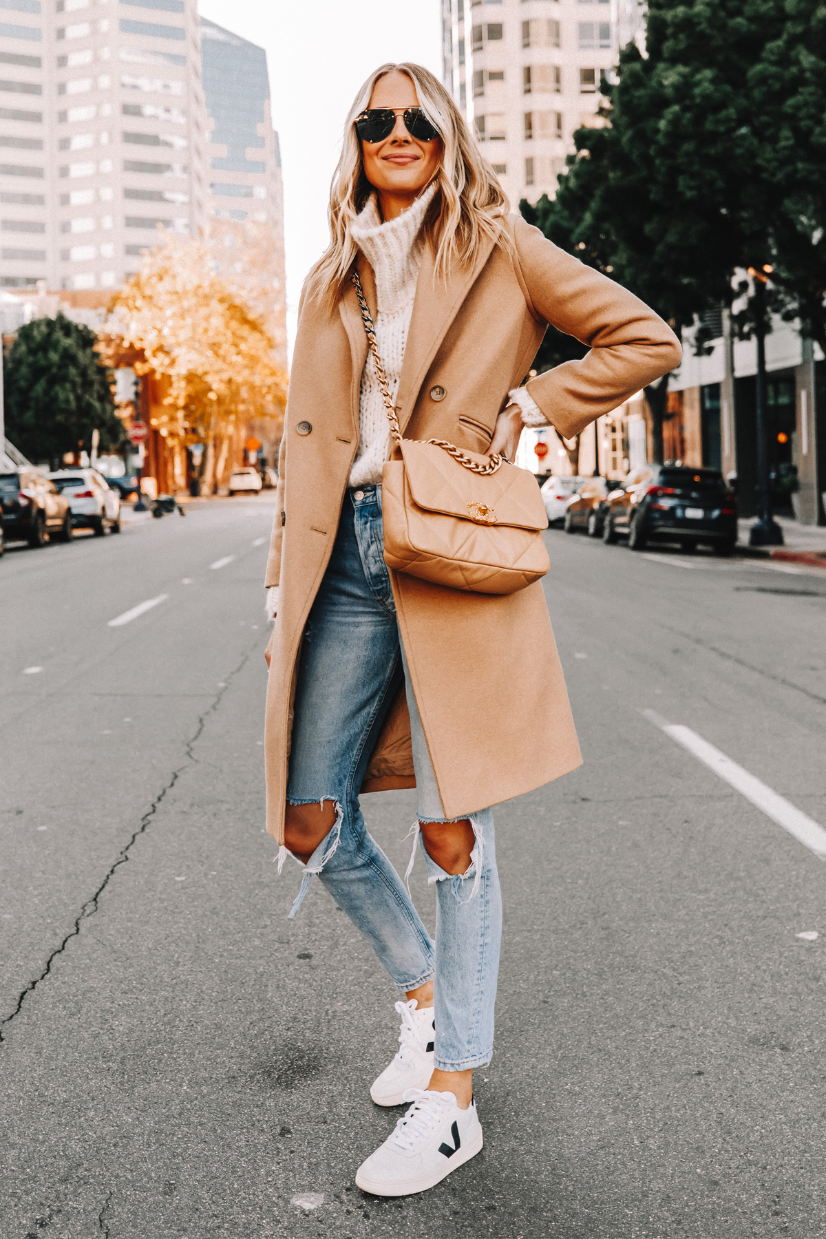 Fashion Jackson Wearing Everlane Camel Coat White Chunky Turtleneck Sweater Ripped Jeans Veja V10 Sneakers Chanel 19 Beige Handbag