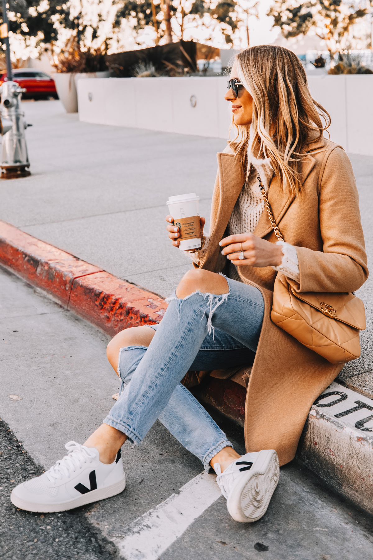 Fashion Jackson Wearing Everlane Camel Coat White Sweater Boyish Ripped Jeans Veja V10 Sneakers Chanel 19 Small Beige Handbag