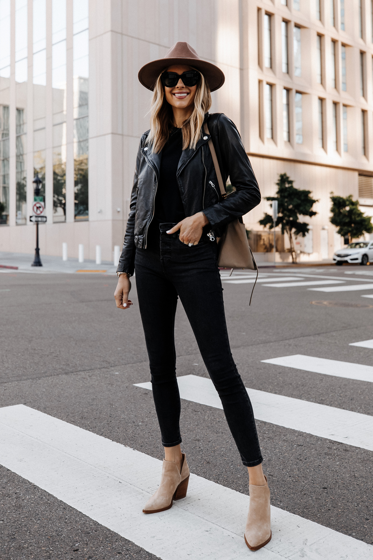 Fashion Jackson Wearing Madewell Black Leather Jacket Black Jeans Vince Camuto Gigetta Tan Suede Booties Tan Wide Brim Hat 1