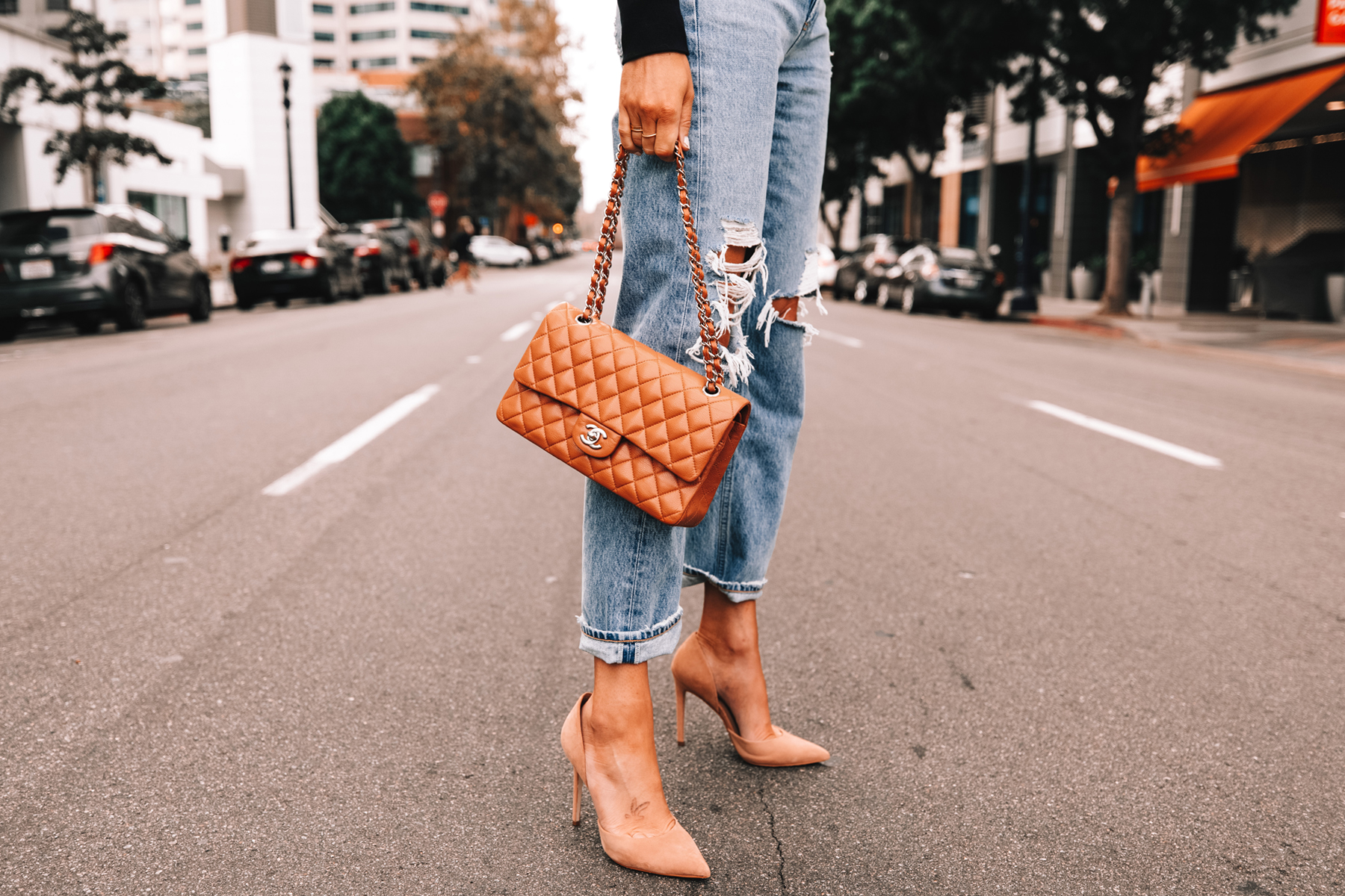 Fashion Jackson Wearing AGOLDE ripped jeans Chanel Camel Handbag Nude Pumps