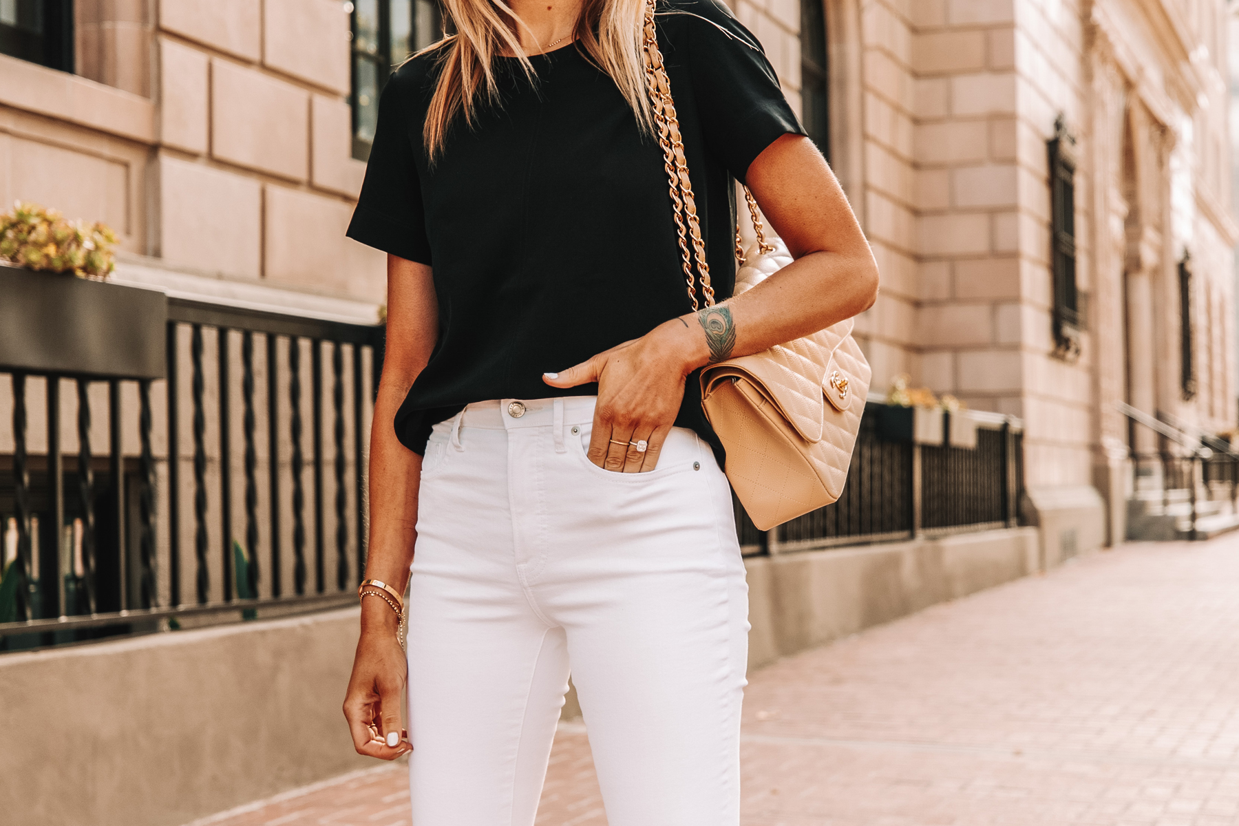 Fashion Jackson Wearing Everlane Black Short Sleeve Top White High Rise Jeans Chanel Beige Handbag 1