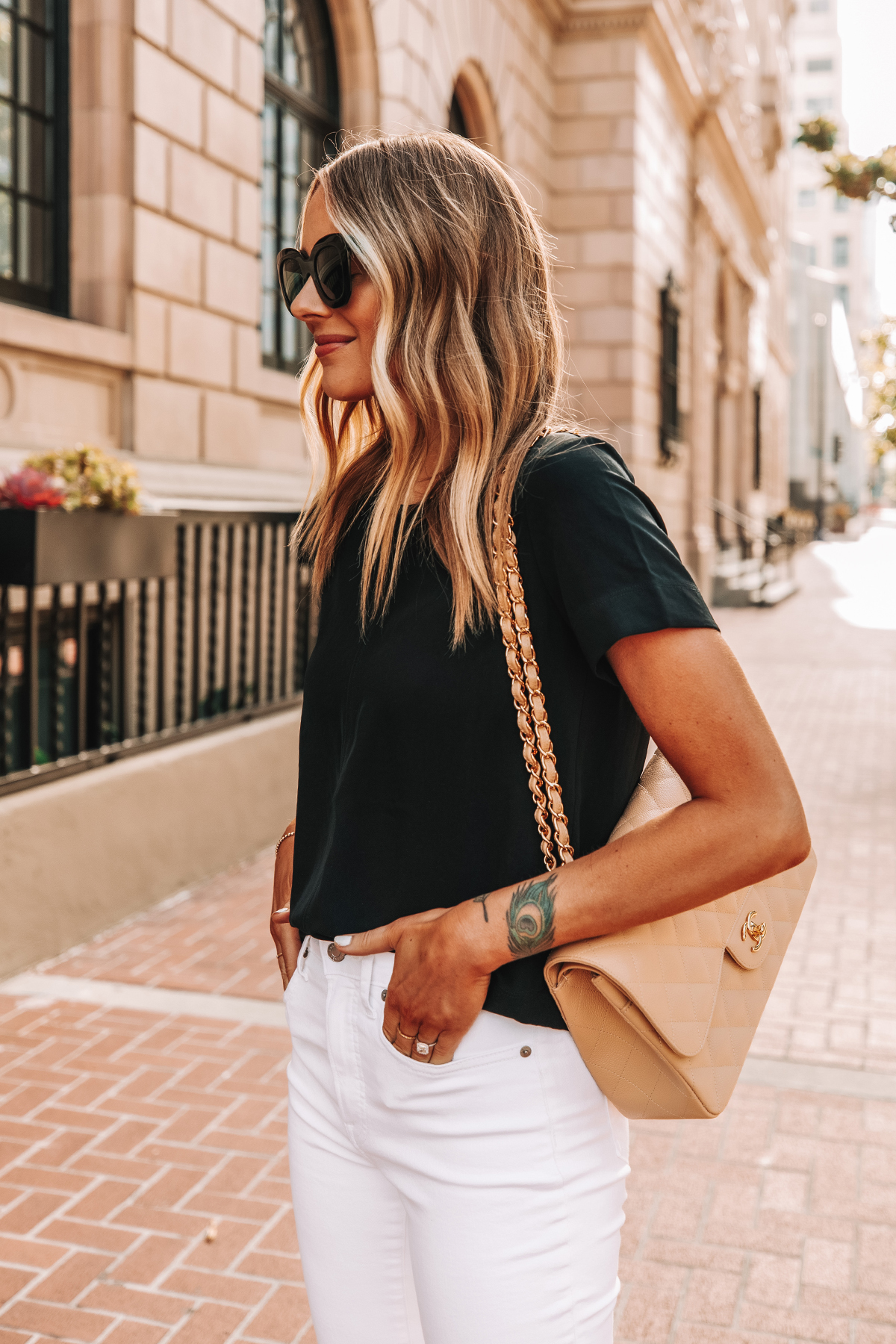 Fashion Jackson Wearing Everlane Black Short Sleeve Top High Rise White Skinny Jeans Chanel Beige Handbag