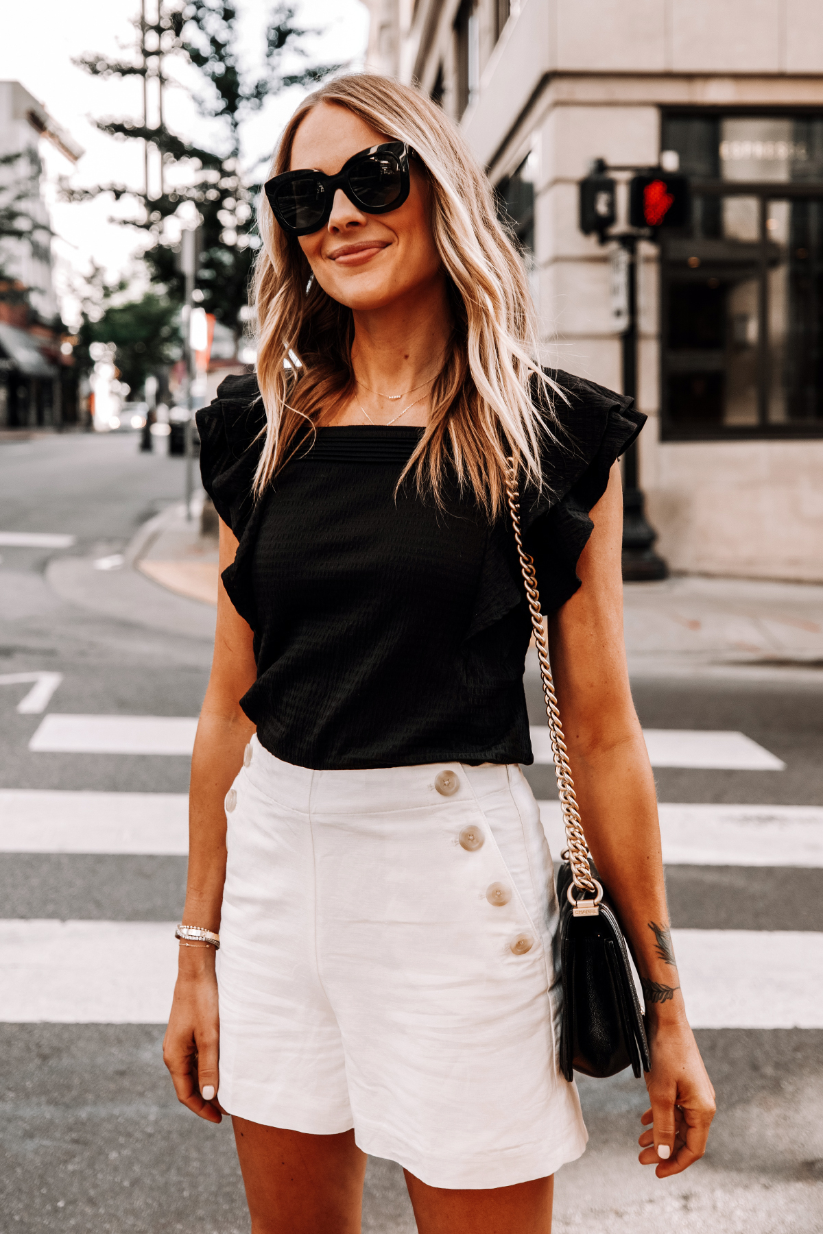 https://fashionjackson.com/wp-content/uploads/2020/07/Fashion-Jackson-Wearing-Black-Ruffle-Sleeve-Tank-White-High-waisted-Button-Sailor-Shorts-2.jpg