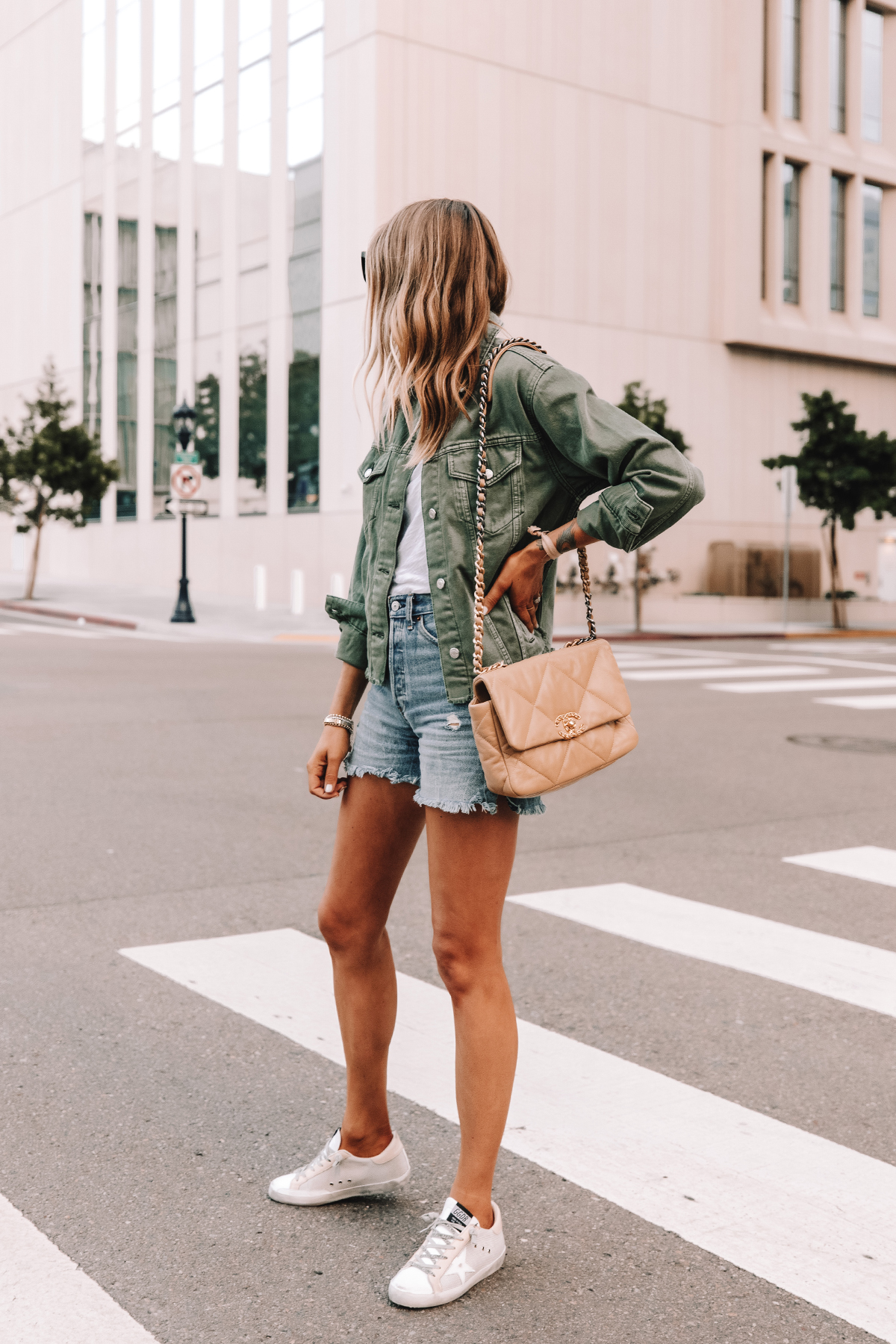 Fashion Jackson Wearing Topshop Olive Green Denim Jacket White Tshirt Ripped Jean Shorts Golden Goose Superstar Sneakers Chanel 19 Beige Handbag