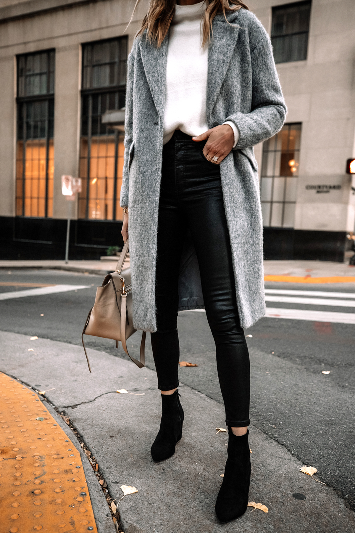 https://fashionjackson.com/wp-content/uploads/2020/11/Fashion-Jackson-Wearing-Express-Long-Grey-Coat-White-Sweater-Black-Coated-Skinny-Jeans-Black-Suede-Booties-1.jpg