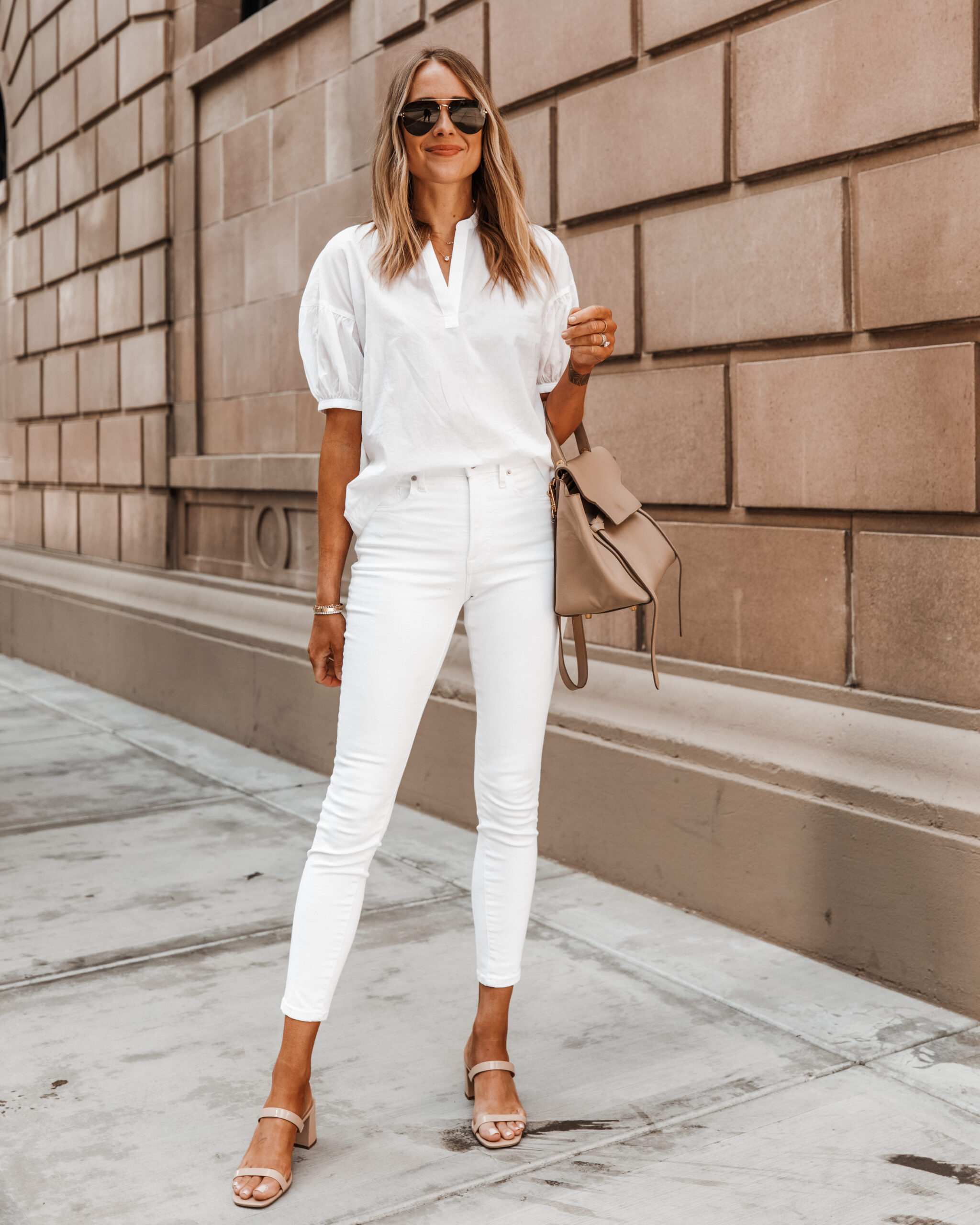 Fashion Jackson wearing white puff sleeve shirt white skinny jeans tan sandals