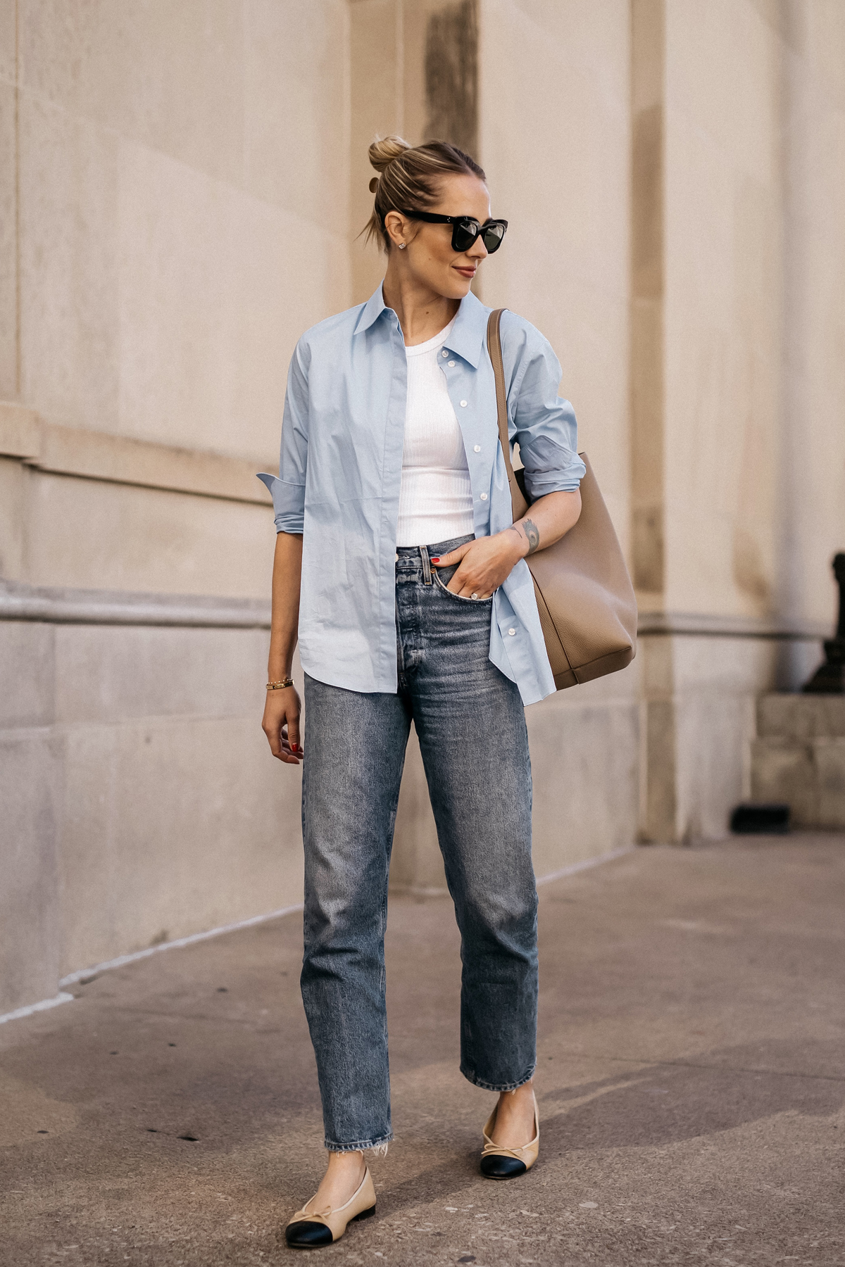 Fashion Jackson Wearing MAYSON the label Blue Button Up Shirt White Tank AGOLDE Jeans Chanel Ballerina Flats Tan and Black The Row NS Large Tote Taupe Casual Street Style Spring Outfit 1