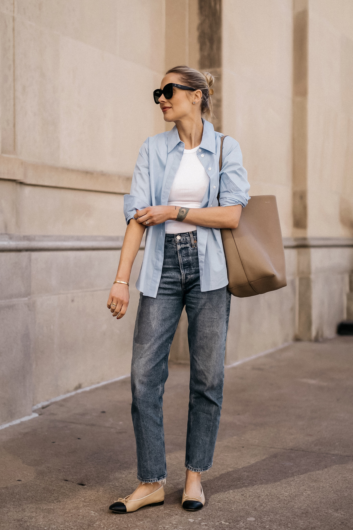 Fashion Jackson Wearing MAYSON the label Blue Button Up Shirt White Tank AGOLDE Jeans Chanel Ballerina Flats Tan and Black The Row NS Large Tote Taupe Casual Street Style Spring Outfit 3