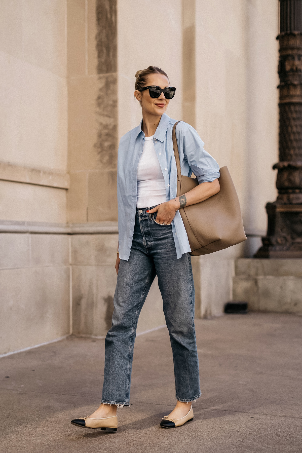 Fashion Jackson Wearing MAYSON the label Blue Button Up Shirt White Tank AGOLDE Jeans Chanel Ballerina Flats Tan and Black The Row NS Large Tote Taupe Casual Street Style Spring Outfit