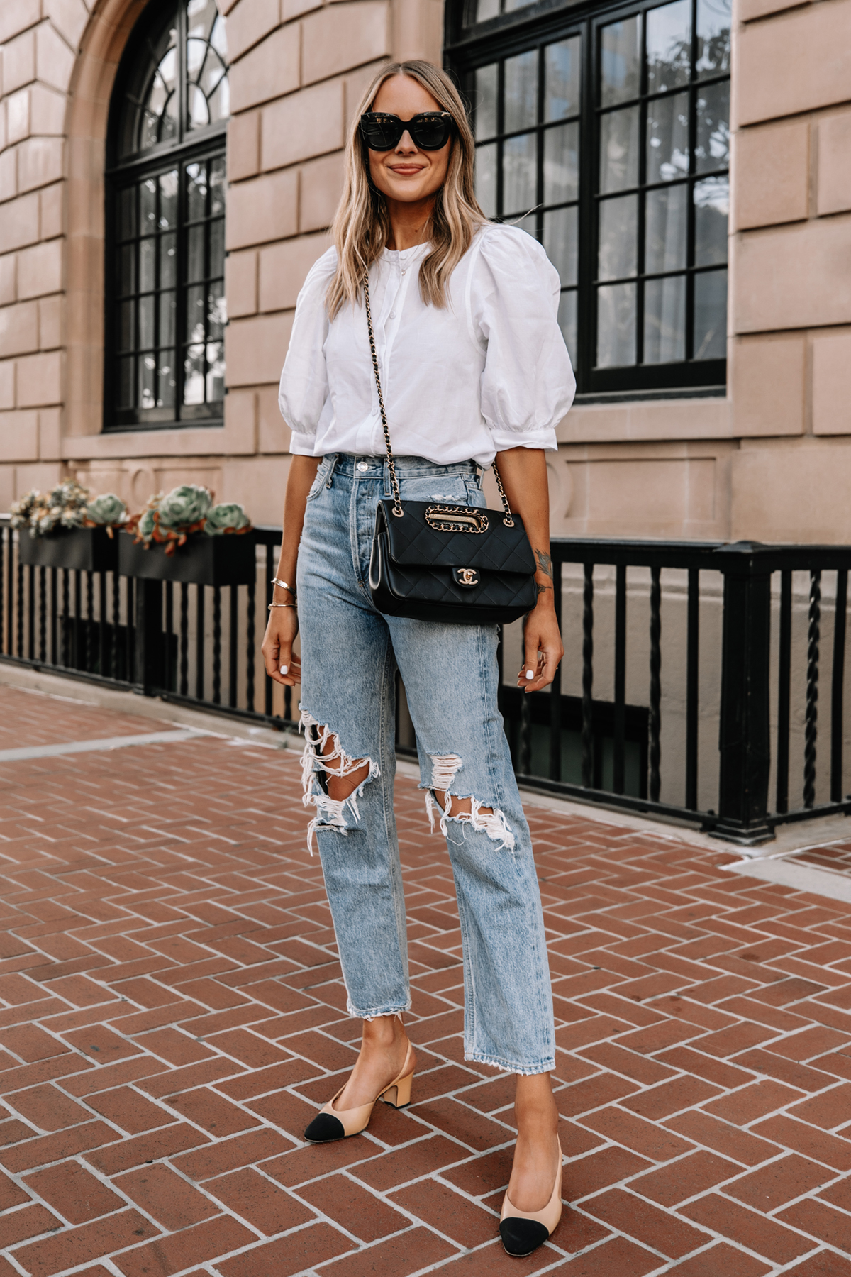 Fashion Jackson Wearing White Button Up Puff Sleeve Top AGOLDE 90s Ripped Jeans Chanel Slingbacks Black Chanel Handbag Street Style 2