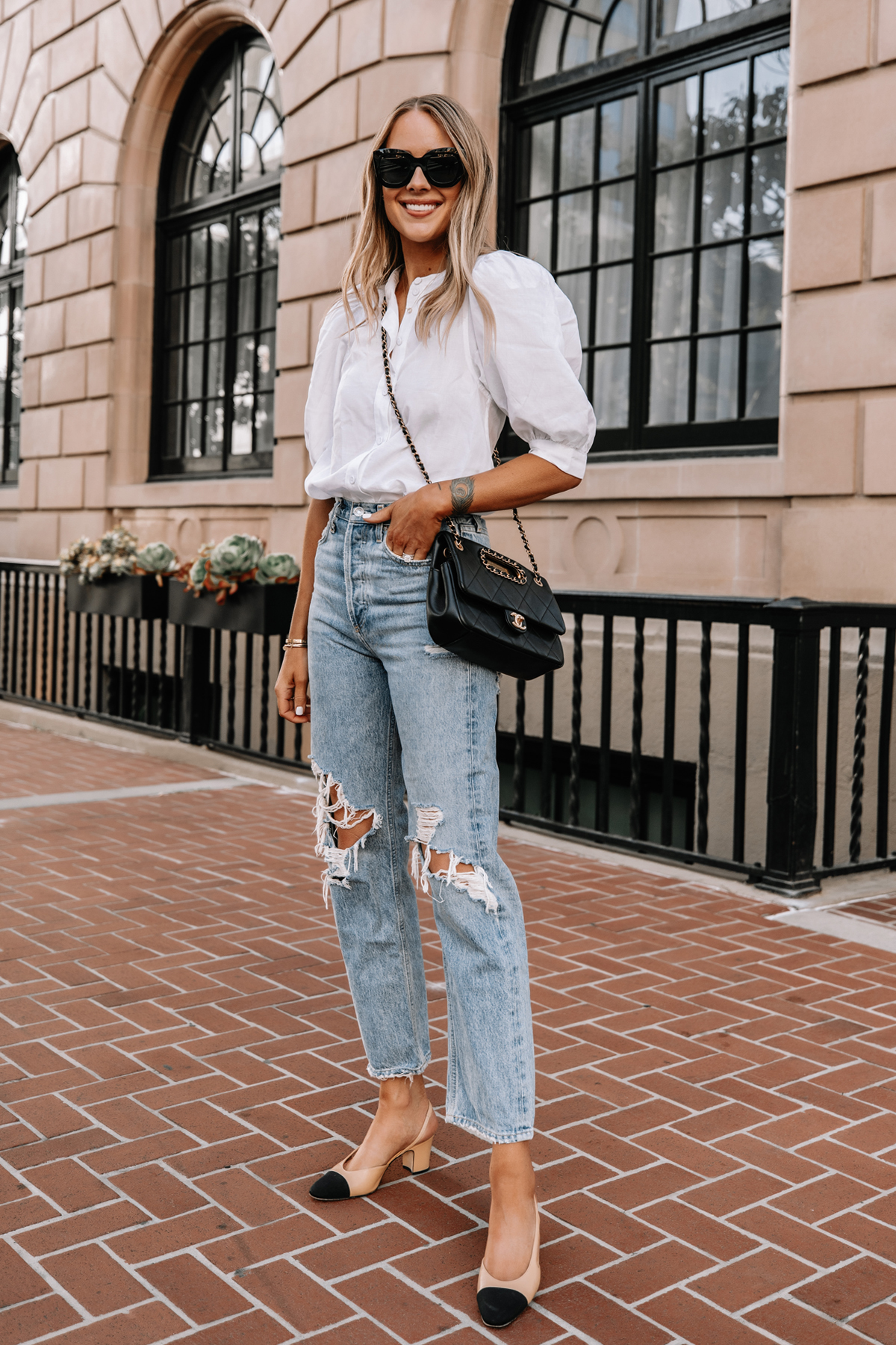 Fashion Jackson Wearing White Button Up Puff Sleeve Top AGOLDE 90s Ripped Jeans Chanel Slingbacks Black Chanel Handbag Street Style