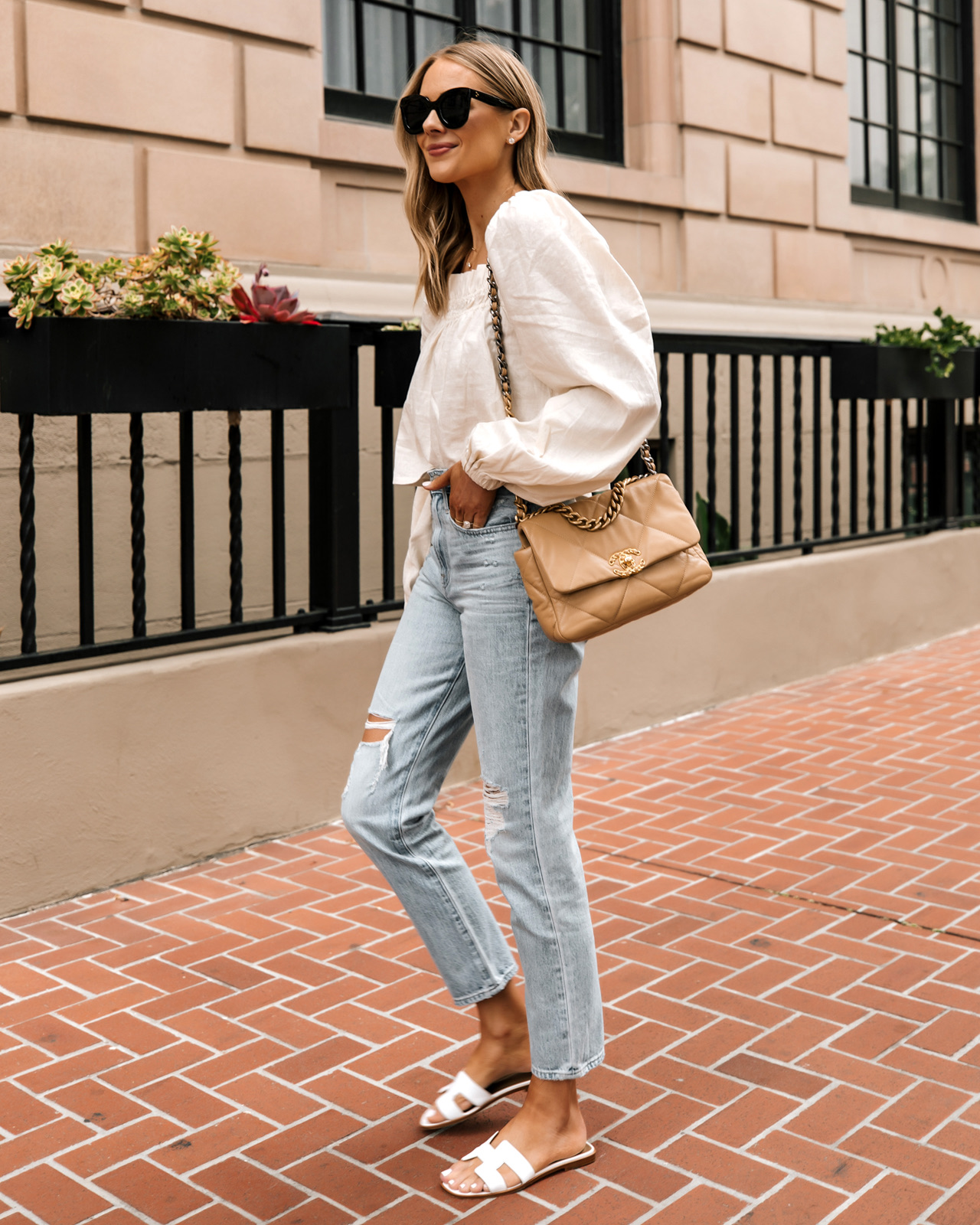 Fashion Jackson Wearing Beige Linen Puff Sleeve Top Madewell Ripped Jeans Hermes White Sandals Chanel 19 Beige Handbag