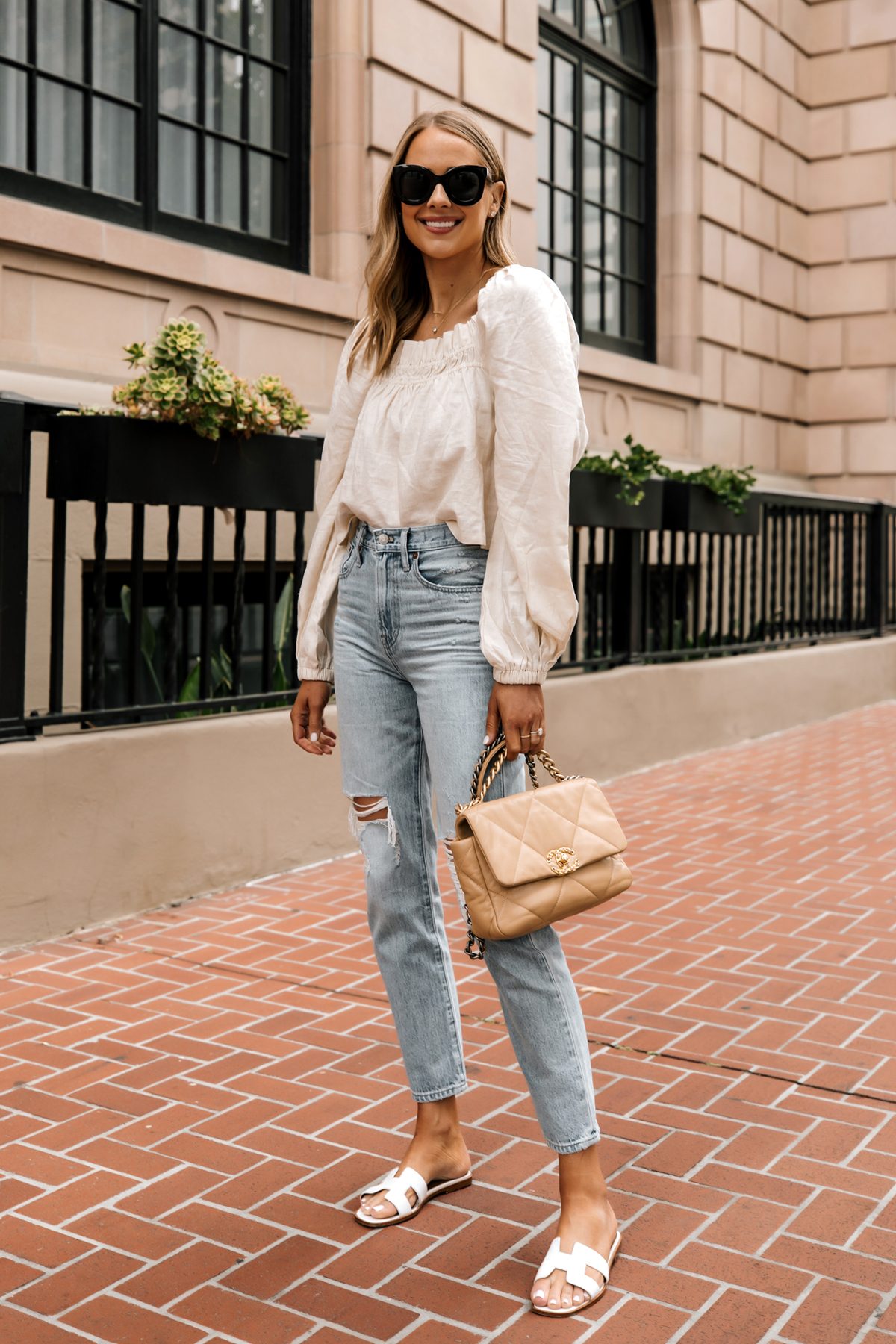 Fashion Jackson Wearing Beige Linen Puff Sleeve Top Madewell Ripped Jeans Hermes White Sandals Chanel 19 Beige Handbag 1