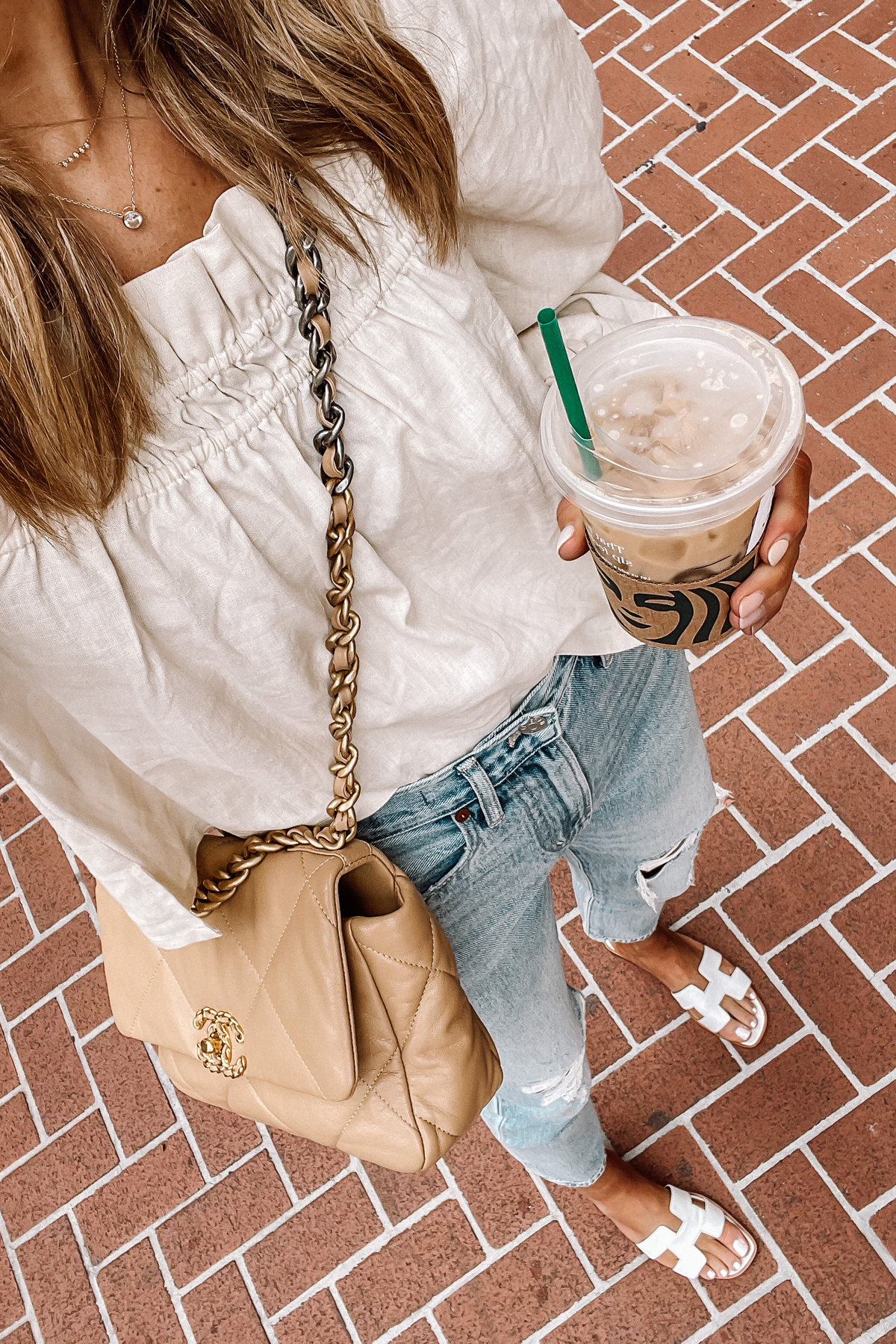 Fashion Jackson Wearing Beige Linen Puff Sleeve Top Madewell Ripped Jeans Hermes White Sandals Chanel 19 Beige Handbag 3