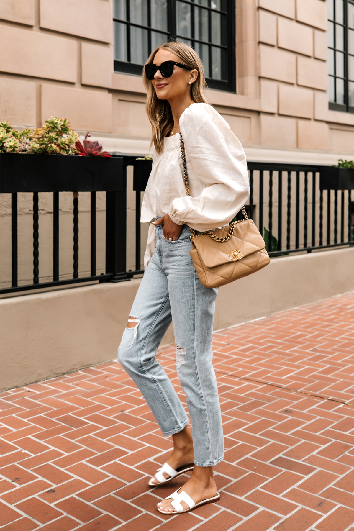 Fashion Jackson Wearing Beige Linen Puff Sleeve Top Madewell Ripped Jeans Hermes White Sandals Chanel 19 Beige Handbag