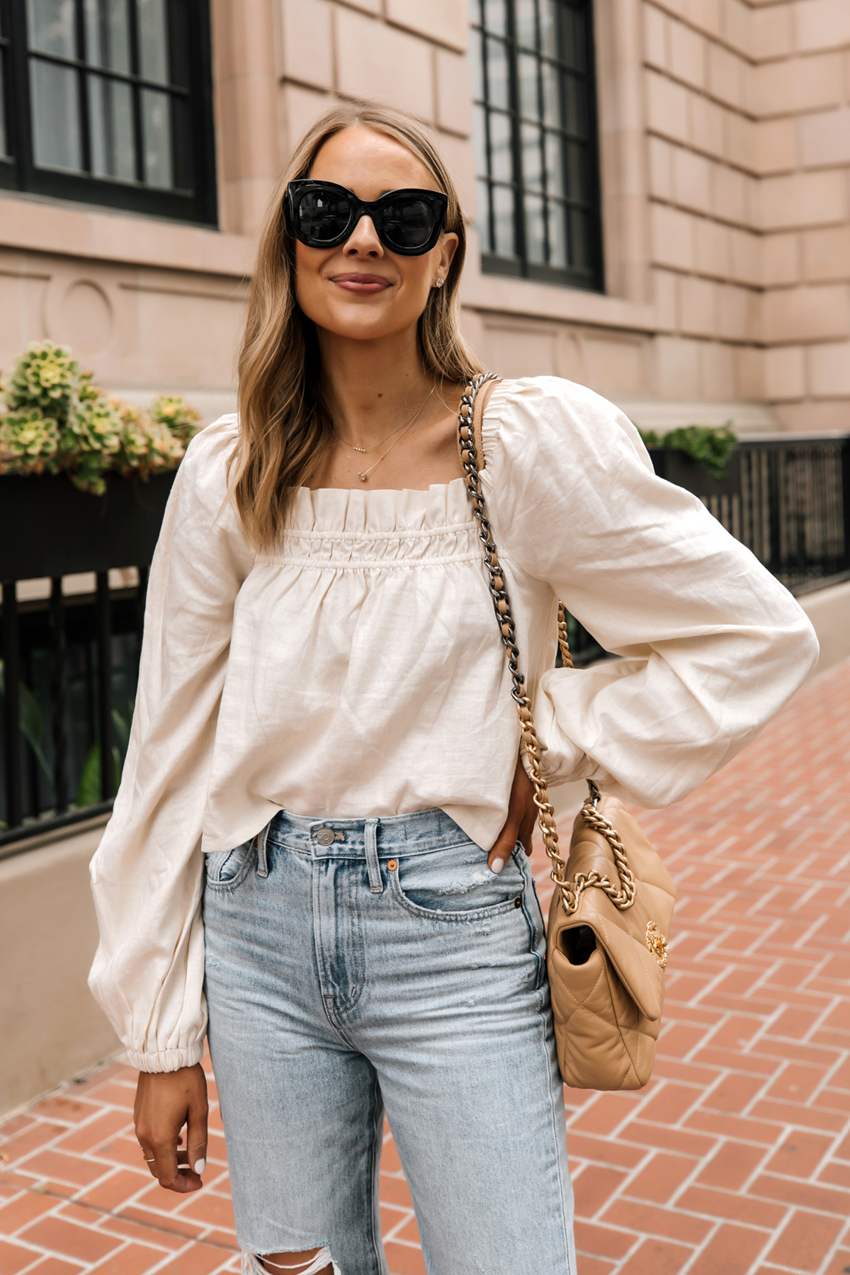 Fashion Jackson Wearing Beige Linen Puff Sleeve Top Ripped Jeans Chanel Beige Handbag