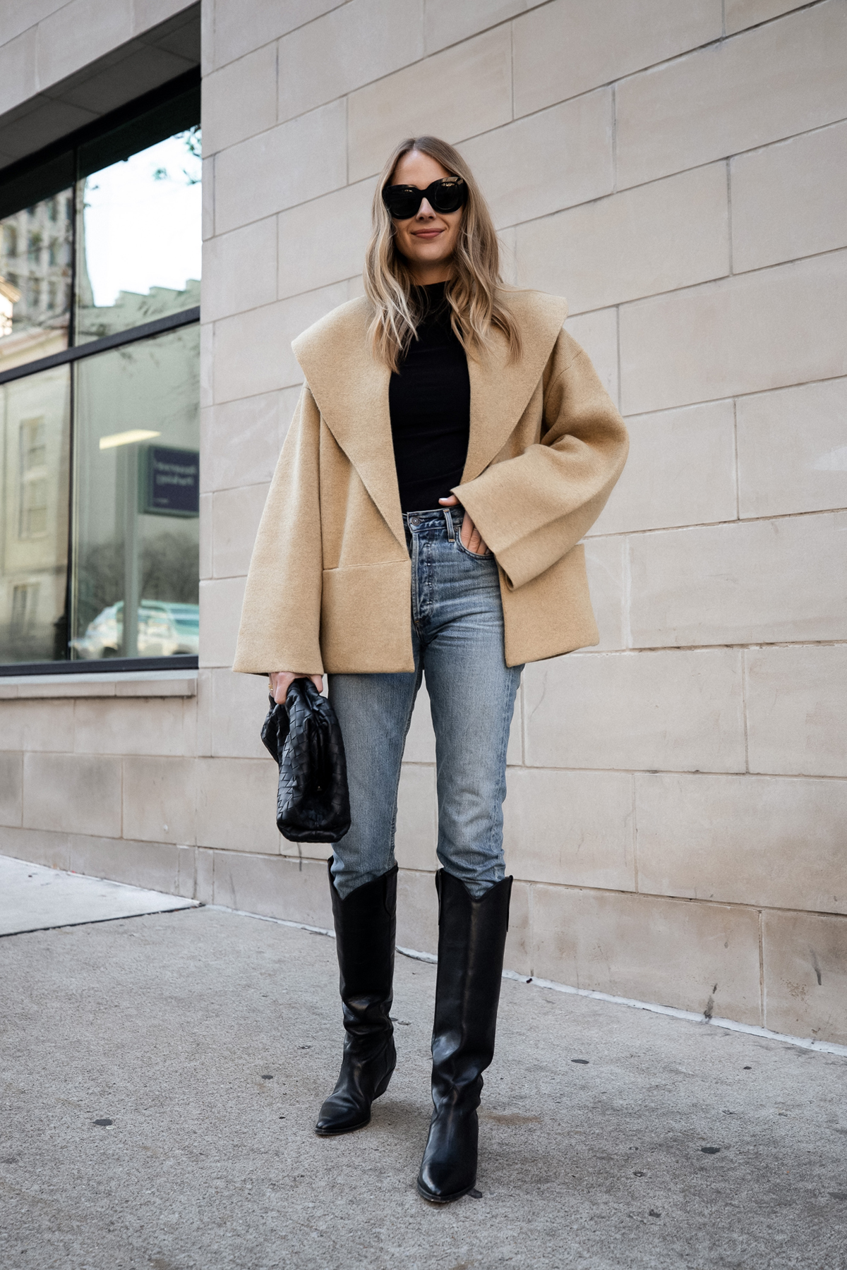 Chic layered fall outfit idea with camel sweater, black denim