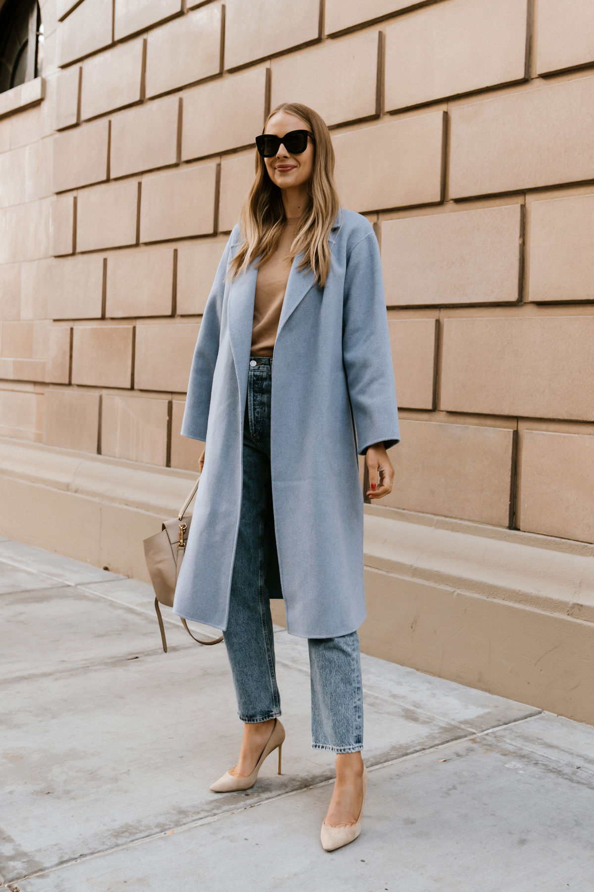 Fashion Jackson Wearing Blue Wrap Coat Camel Sweater AGOLDE 90s Jeans Jimmy Choo Nude Pumps Celine Belt Bag Winter Street Style