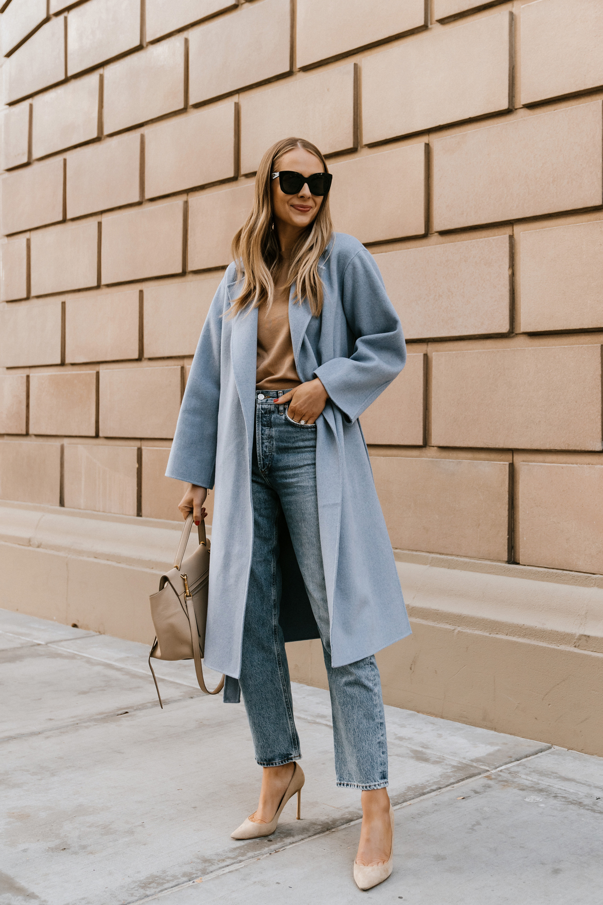 Fashion Jackson Wearing Blue Wrap Coat Camel Sweater AGOLDE 90s Jeans Jimmy Choo Nude Pumps Celine Belt Bag Winter Street Style