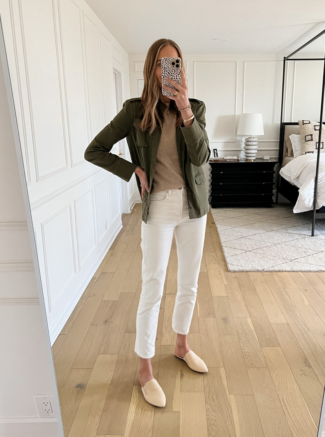 Fashion Jackson Wearing Spring Capsule Wardrobe Outfit, Green Utility Jacket, Tan Sweater, White Jeans, Beige Mules, Spring Outfit