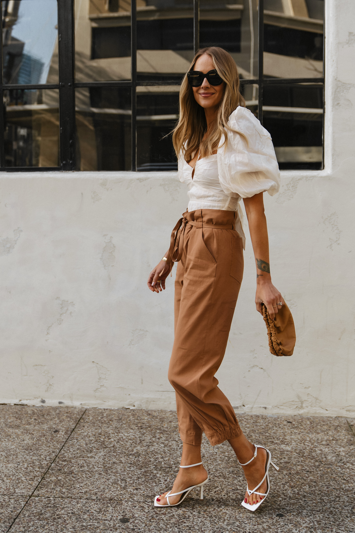 Fashion Jackson Wearing puff sleeve crop top outfit brown pants womens outfit bottega veneta stretch sandals white chic spring outfit 2022 street style