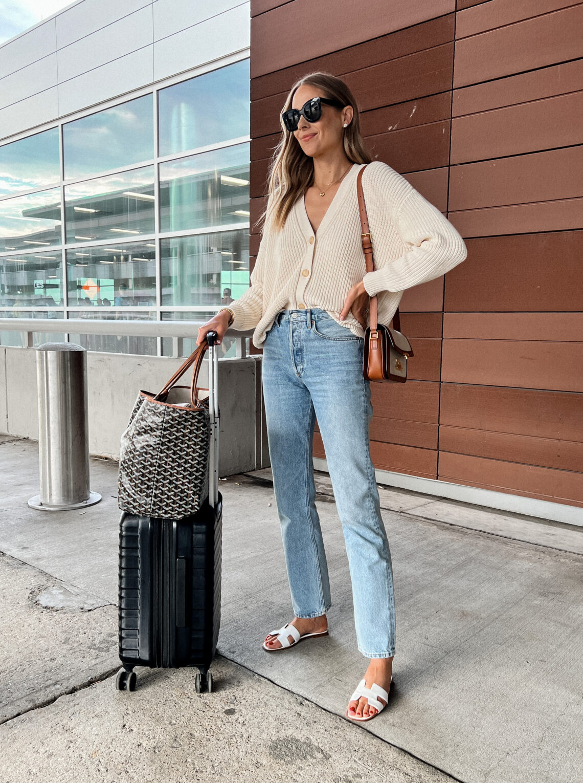 Fashion Jackson Wearing Jenni Kayne Cotton Cardigan AGOLDE Lana Jeans Hermes White Sandals Travel Outfit Amazon Luggage Goyard Tote