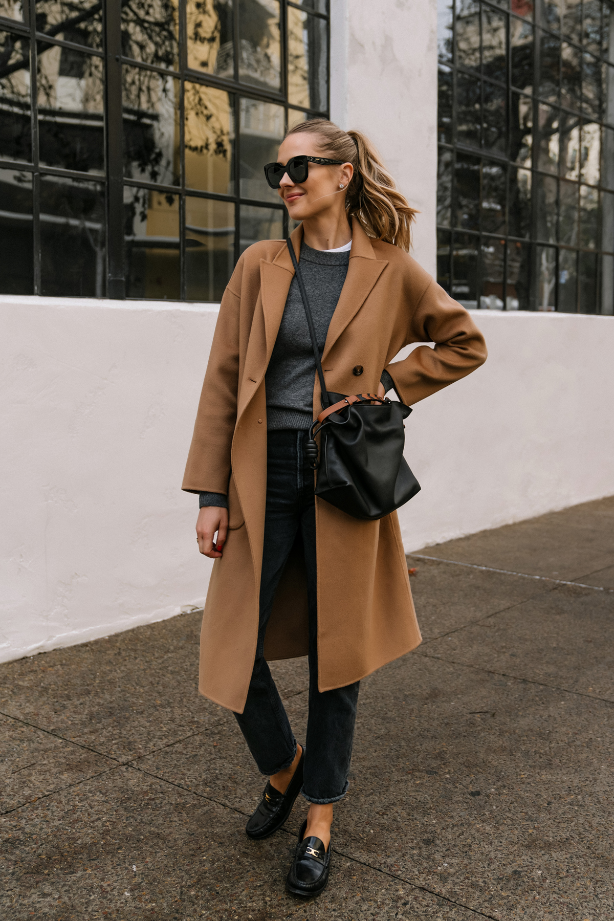 Chic layered fall outfit idea with camel sweater, black denim