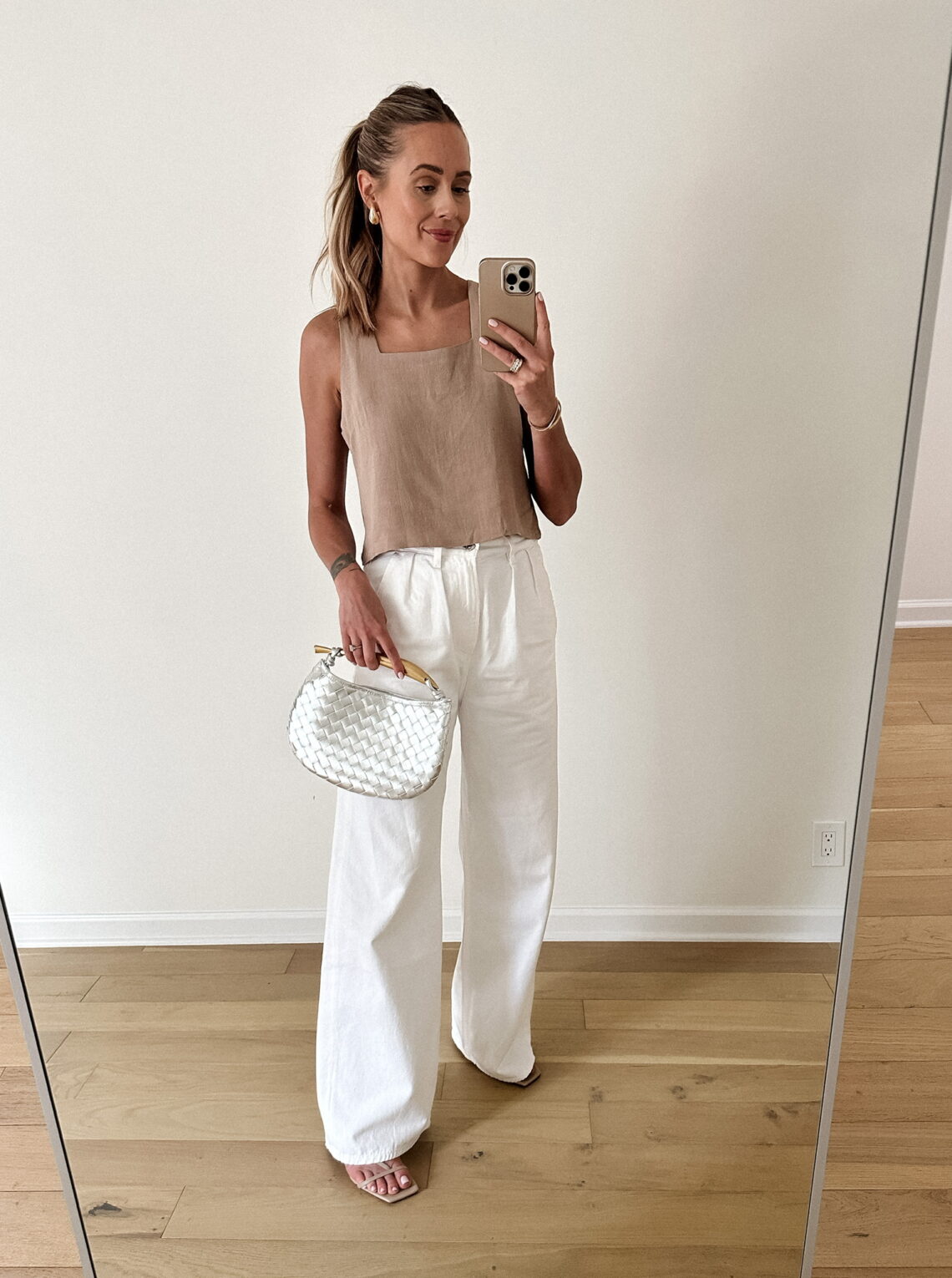 Fashion Jackson Wearing Beige Linen Tank Citizens of Humanity White Trouser Jeans Nude Sandals Metallic Silver Woven Clutch Summer Date Night Outfit