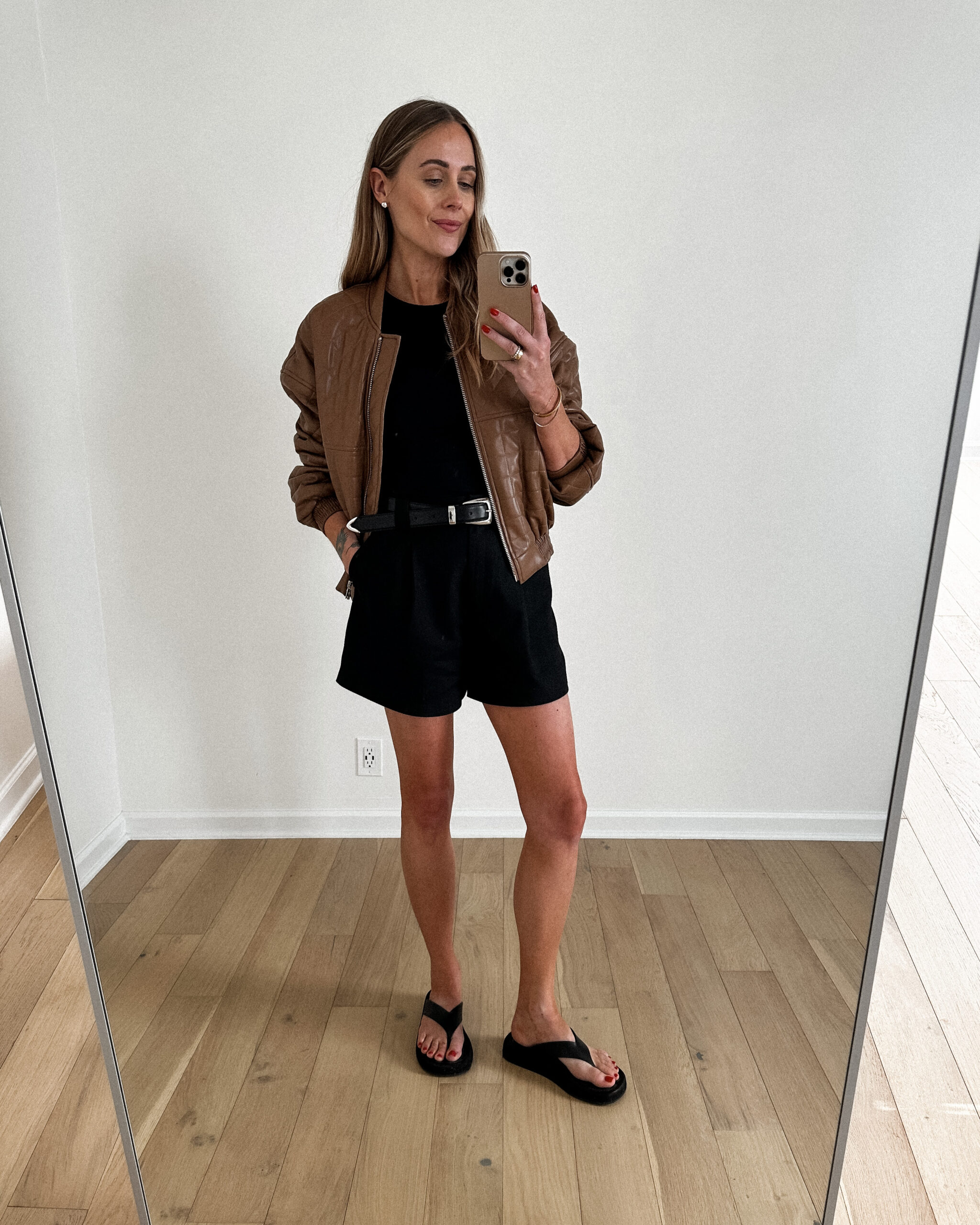 Fashion Jackson Wearing MAYSON the label Brown Quilted Vegan Bomber Jacket black rib fitted tank, black trouser shorts, the row blackck ginza leather suede sandals, casual outfit