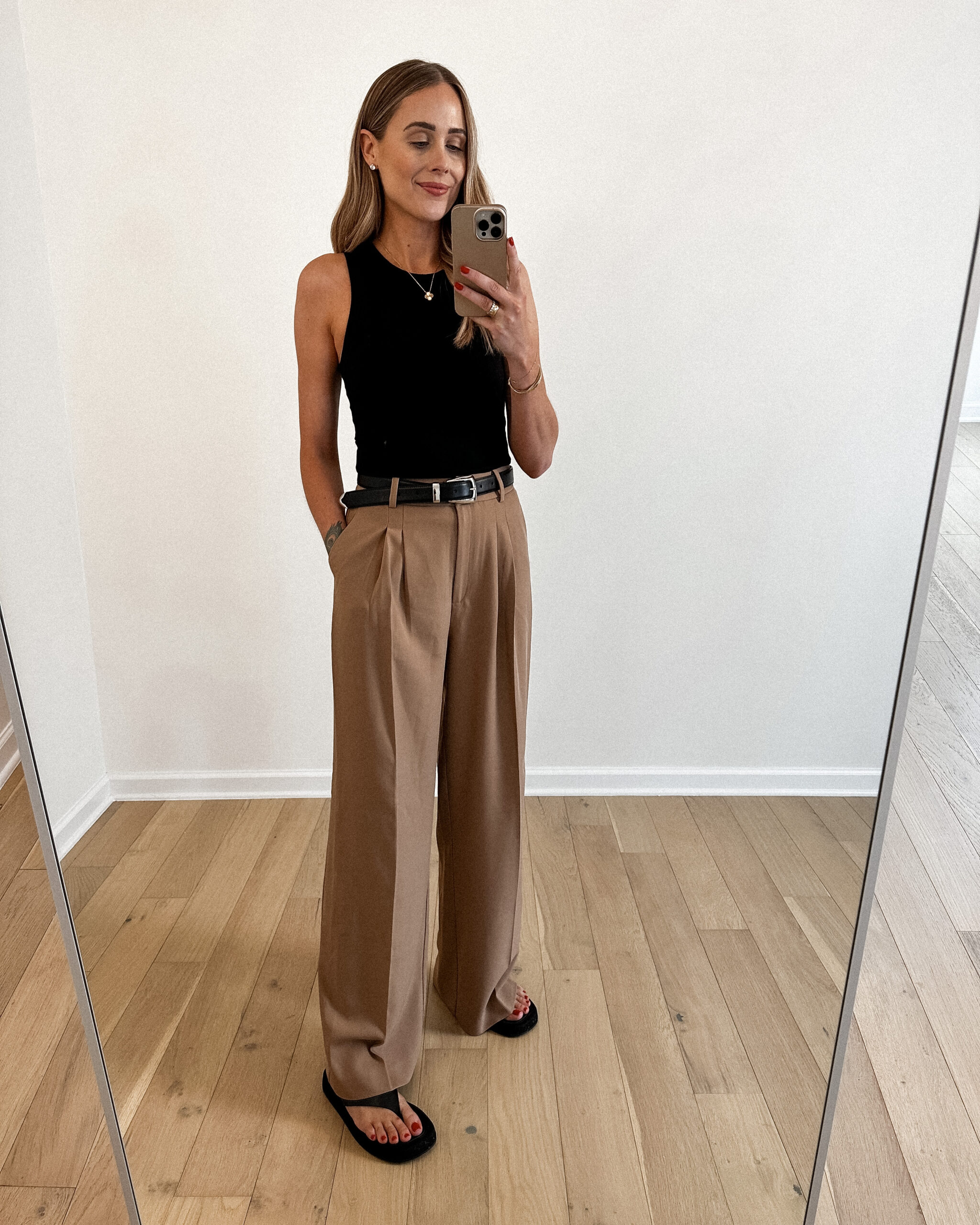 Fashion Jackson Wearing MAYSON the label black rib fitted tan,, camel wide leg trousers, khaite black benny belt, the row black ginza leather suede sandals, casual outfit