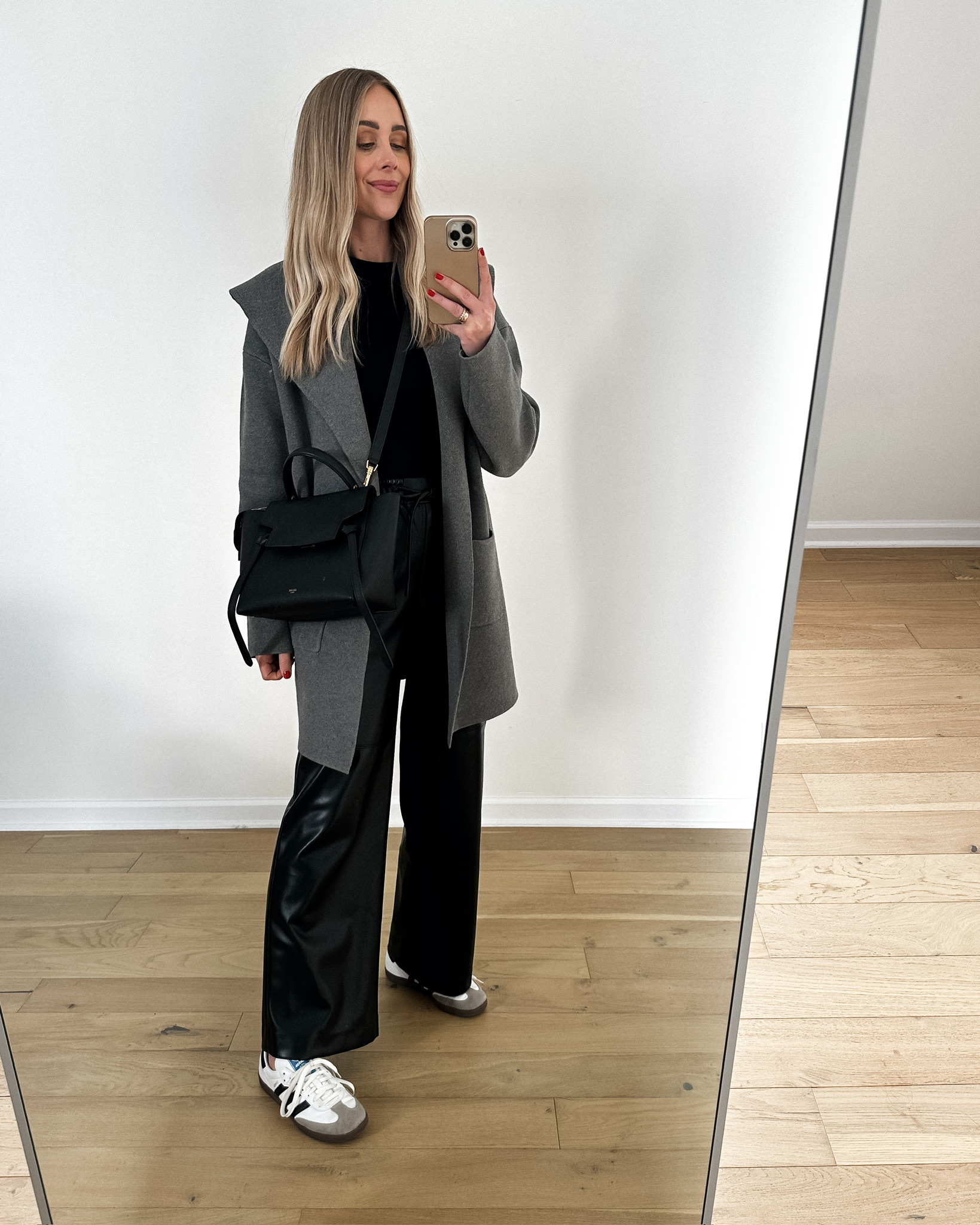 Fashion Jackson wearing MAYSON the label grey coatigan, MAYSON the label vegan leather pants, Adidas Samba sneakers, travel outfit, fall outfit, winter outfit