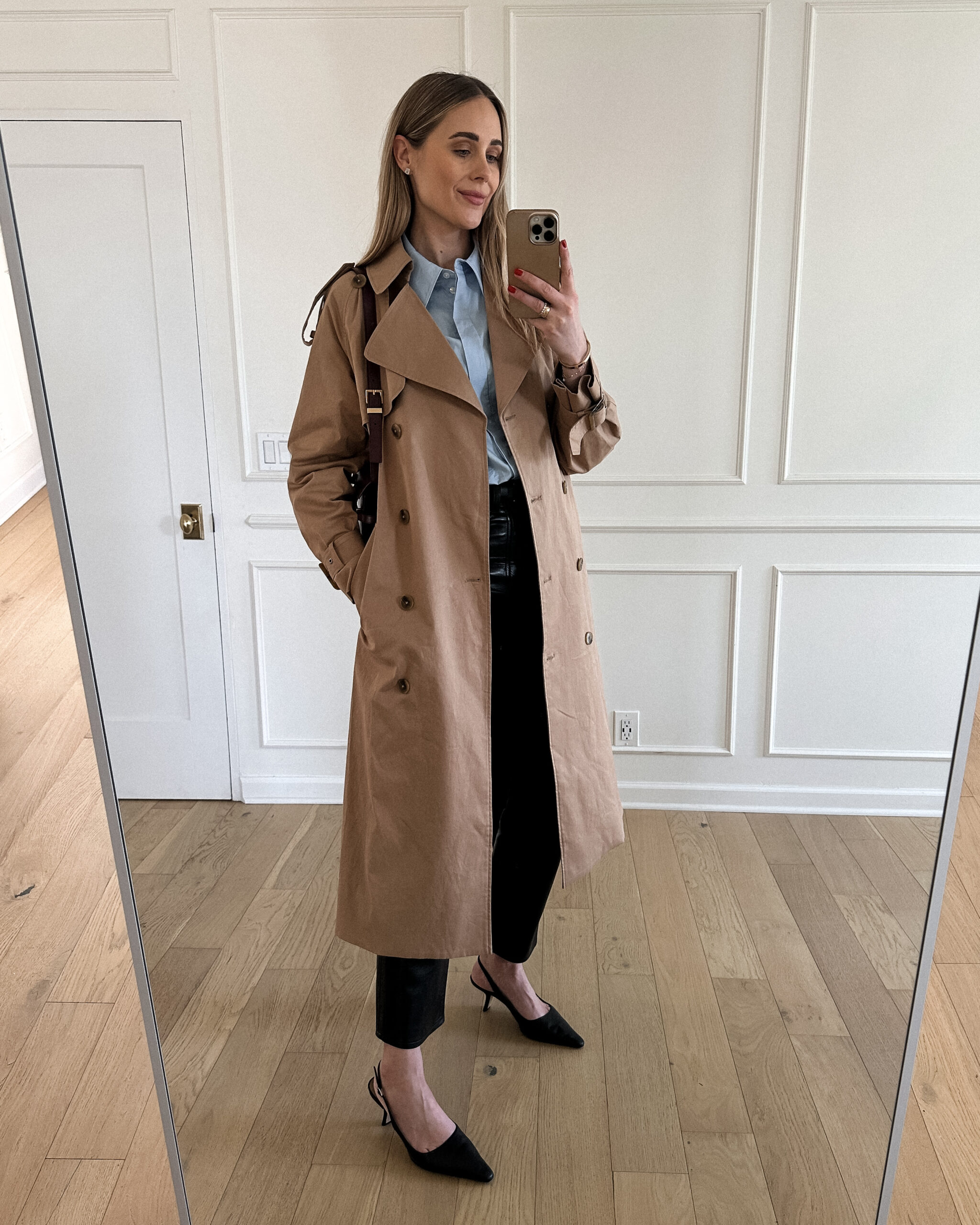 Fashion Jackson Wearing Mayson the label long trench coat, mayson the label french blue button up shirt, agolde black leather pants, black slingbacks